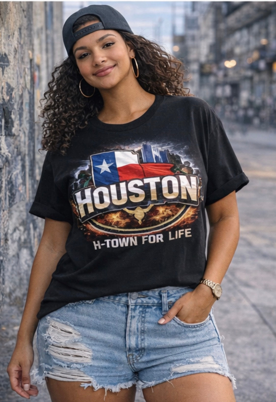 Woman wearing a black t-shirt with 'Houston H-Town for Life' design on a city street.
